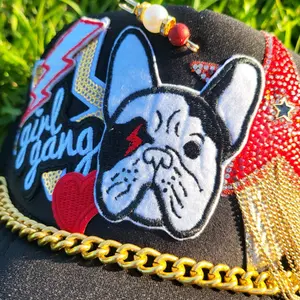 Girl Gang Frenchie Bulldog Otto trucker hat with red and black embellishments.