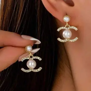 Gold-Tone Interlocking "C" Pearl Drop Earrings with Crystal Accents.