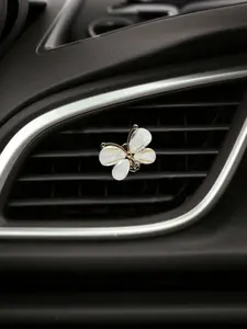 Elegant white seashell butterfly car vent clip, luxurious yet minimalist car accessory.