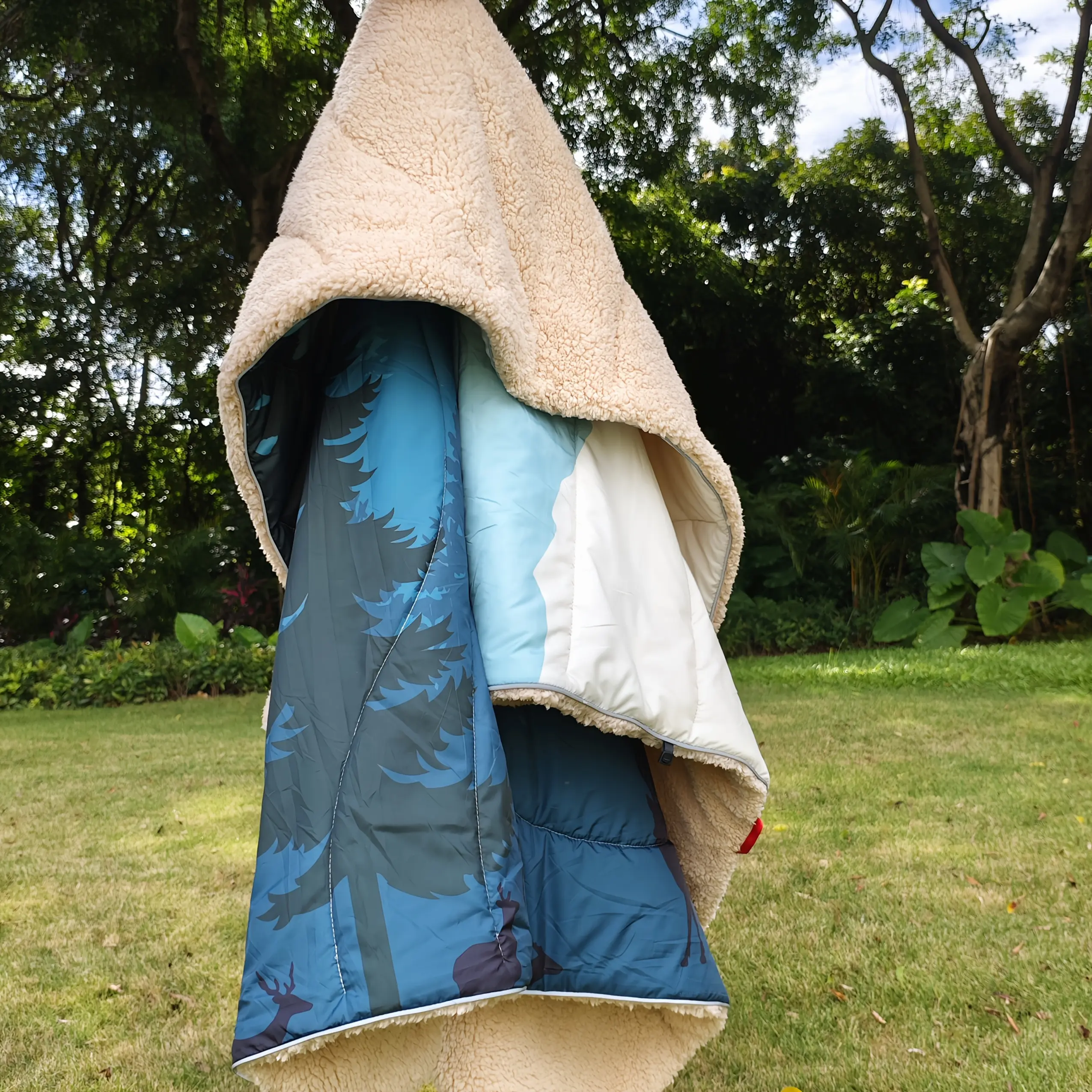 A Camping Blanket Designed for Outdoor Use Featuring a Sherpa Lining, Providing Extra Warmth. This Thick And Puffy Ultralight Poncho Quilt Is Suitable for Cold Weather Adventures, Sleeping, And Backpacking, Measuring 79 Inches by 55 Inches