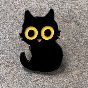 Wide eyed black kitty enamel pin