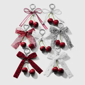 1 piece rustic-style, simple, versatile, fashionable handmade beaded keychain featuring white faux pearls, CCB leopard print lace ribbon bow, and foam cherry; bag charm/hanger suitable for girls’ everyday wear and as a holiday gift.