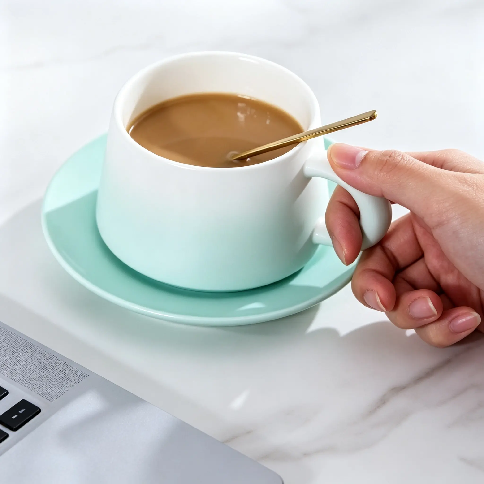 Elegant White Coffee Cup with Mint Green Saucer and Gold Spoon for a Stylish Beverage Experience
