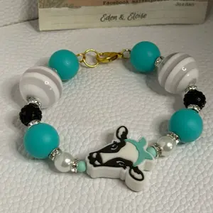 Handmade cow charm with teal and white and black bead bracelet