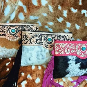 Tooled leather crossbody with fringe and cowhide