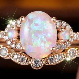 A champagne gold egg-shaped light pink Opal white diamond ring set is suitable for women to wear as a gift on wedding Valentine's Day