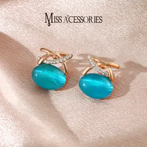 Blue Cat Eye Oval Earrings | Sparkly CZ Crisscross Rose Gold Tone | Viral Simulated Cat Eye Dangle Earrings | Luxury Blue Cat Eye Statement Earrings | Timeless Evening Wear Jewelry | Birthday Gift Idea | Sparkly Simulated Cat Eye Dangle Earrings