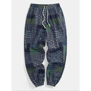 Men’s jogger pants with ethnic pattern patchwork, drawstring elastic waistband, boho casual loose fit with pockets, suitable for spring and fall—fashionable men’s bottoms for daily wear and casual sports.