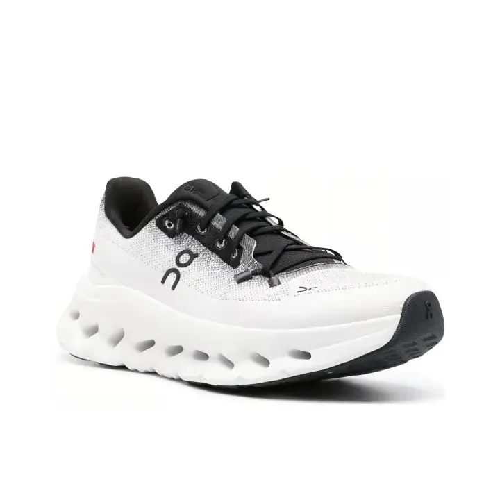 White Black Low Top Running Sneakers  Breathable knit mesh upper with white-black gradient design, unique hollow curved midsole delivers ultra-soft cushioning. Durable black rubber outsole offers solid grip. Quick lace closure,