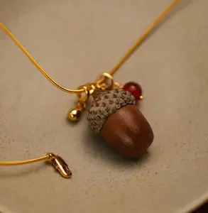 This forest-themed pine nut and acorn necklace is a unique and stylish Instagram accessory