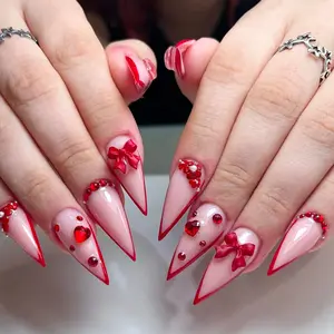 24 pcs long, pointed press-on nails, Nail art design, for Valentine's Day, featuring red hearts, gemstones, 3D bows, romantic red five-petal flowers, and irregular red French tips with jelly glue and a nail file
