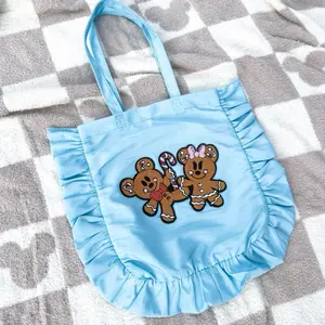 Very Merry Gingerbread Ruffle Tote - Plush Chenille Cookie Patch, Ruffle Trim, Interior Divider, Blue, Ivory, Pink, 12.5"x13" Capacity, 16.5"x15" with Ruffle, Part of the Very Merry Gingerbread Collection
