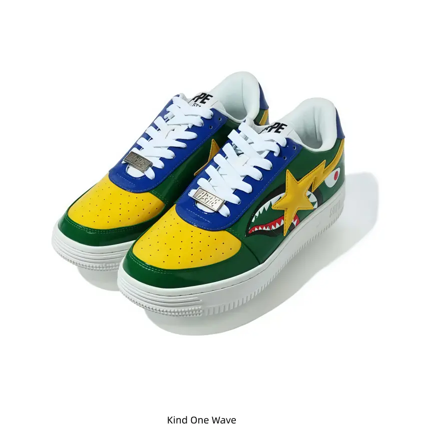 Color-block BAPE STA low-top sneakers with shark mouth graphic, yellow star logo, WGM lettering on heel, bright retro street design for sneaker collectors and bold daily street styling