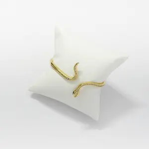 A bold and captivating golden snake bracelet, designed with a sleek, coiled silhouette that wraps elegantly around the wrist. Made from high-quality, gold-plated alloy with intricate scale detailing and a polished finish that shimmers with every move.