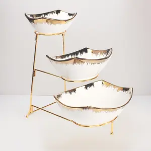 Three-Tier Ceramic Bowl Rack Features a Foldable Gold Stand and Three Gold-Rimmed 7.1-inch/8.5-inch/10.2-inch Bowls for displaying Food, Fruit, Desserts, and Serving Guests.