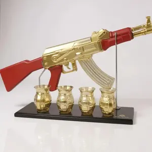 AK47 Gold Gun Decanter Set with Red Accents and Four Gold Glasses on Black Base