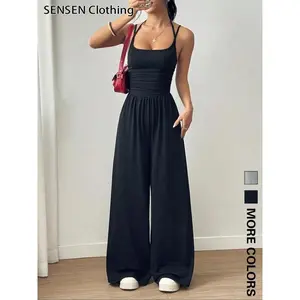 Elegant women's tight fitting jumpsuit with sleeveless backless design and high waisted pleated details, perfect for parties and eventsRAIMENTRY