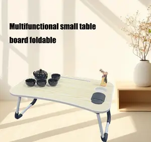 Laptop portable bed table with tablet slot and cup holder, can accommodate laptops under 15.6 inches, anti-slip and folding features, suitable for work, eating and watching movies