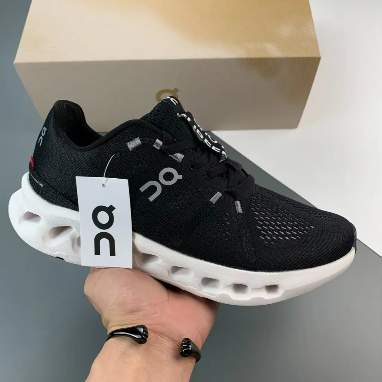 Low-top running trainers perfect for daily jogging & casual weekday office commutes, ultra-light perforated stretch knit mesh solid black silhouette, open mesh airflow channels, tough textured rubber outsole boosts traction on city pavement surfaces