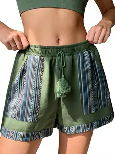 A pair of women's shorts with a drawstring waistband, Boho fringed decoration, striped and geometric pattern patchwork in dark green, suitable for summer, style, casual street style, and daily outing or beach play, Bohemian