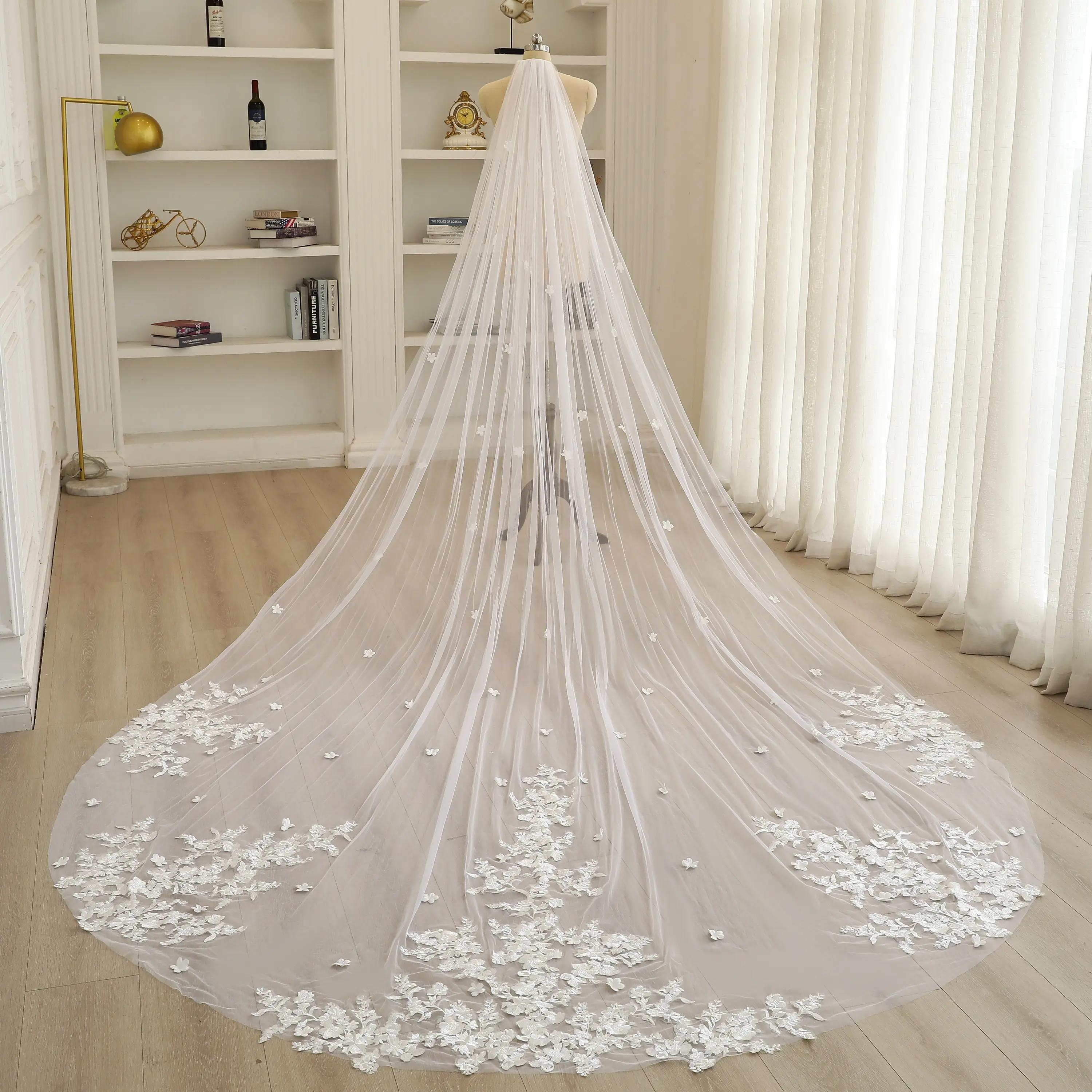 3D floral design: Large, layered, and full flower clusters with leaves on a soft tulle bridal veil.