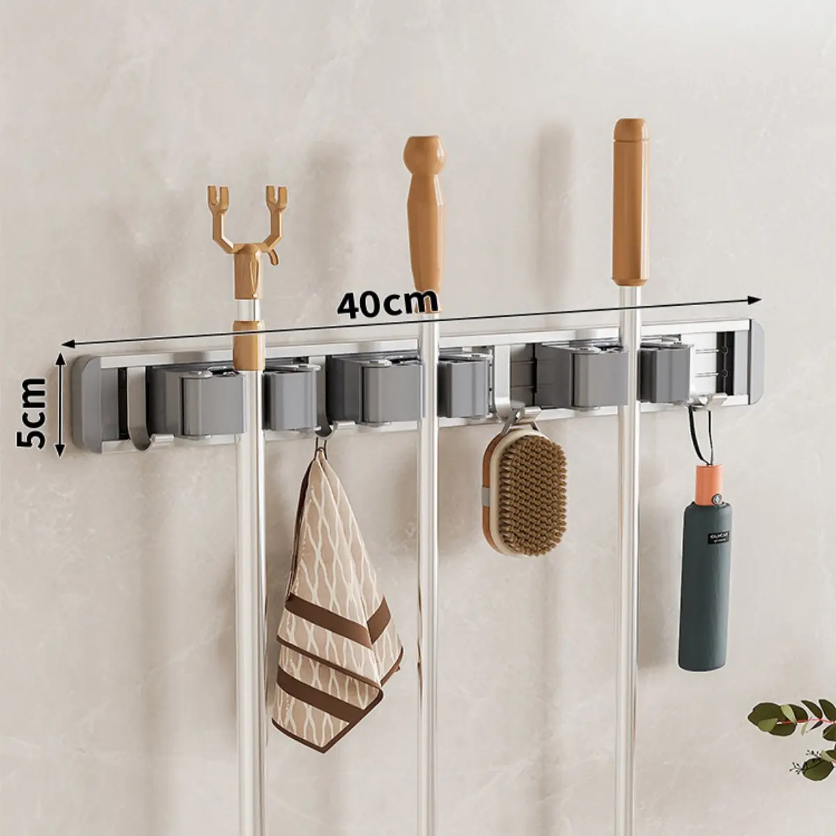 A sturdy metal mop, vacuum cleaner and broom holder, easy to install and requires no drilling. This robust storage rack comes with adjustable hooks and is wall-mounted. Suitable for homes, kitchens, outdoor gardens, bathrooms, laundries and garages