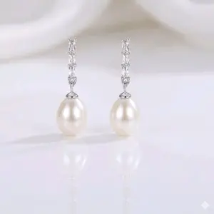 earrings feature pure 925 sterling silver, adorned with natural freshwater pearls and cubic zirconia, and are designed with a pushback closure.