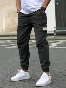 Men’s casual solid-color cargo pants with multiple flap pockets, a drawstring waist, and a tapered leg; suitable for daily commuting, outdoor leisure, and work.