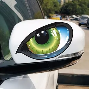 Two imaginative vehicle decals, with striking three-dimensional green cat eyes, as if they are looking at you