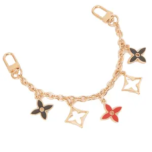 Gold Tone 5 Flower Star Black and Red 9.5 Inch Bag Charm