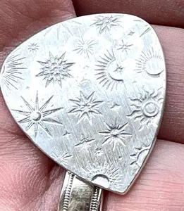 Sterling silver guitar pick with cosmic pattern