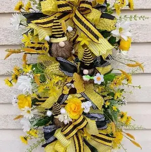 Gnome Bee Stir Stick Wreath with Gnome Bee picks, a beehive pick, yellow and white flowers, ribbon, and a bow