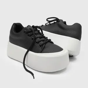 Men’s Black & White Ultra‑Chunky Leather Sneakers. Grainy black leather upper paired with voluminous white platform sole delivers modern street style. Lace‑up construction ensures comfy fit, while the thick sole offers height‑boosting effect.