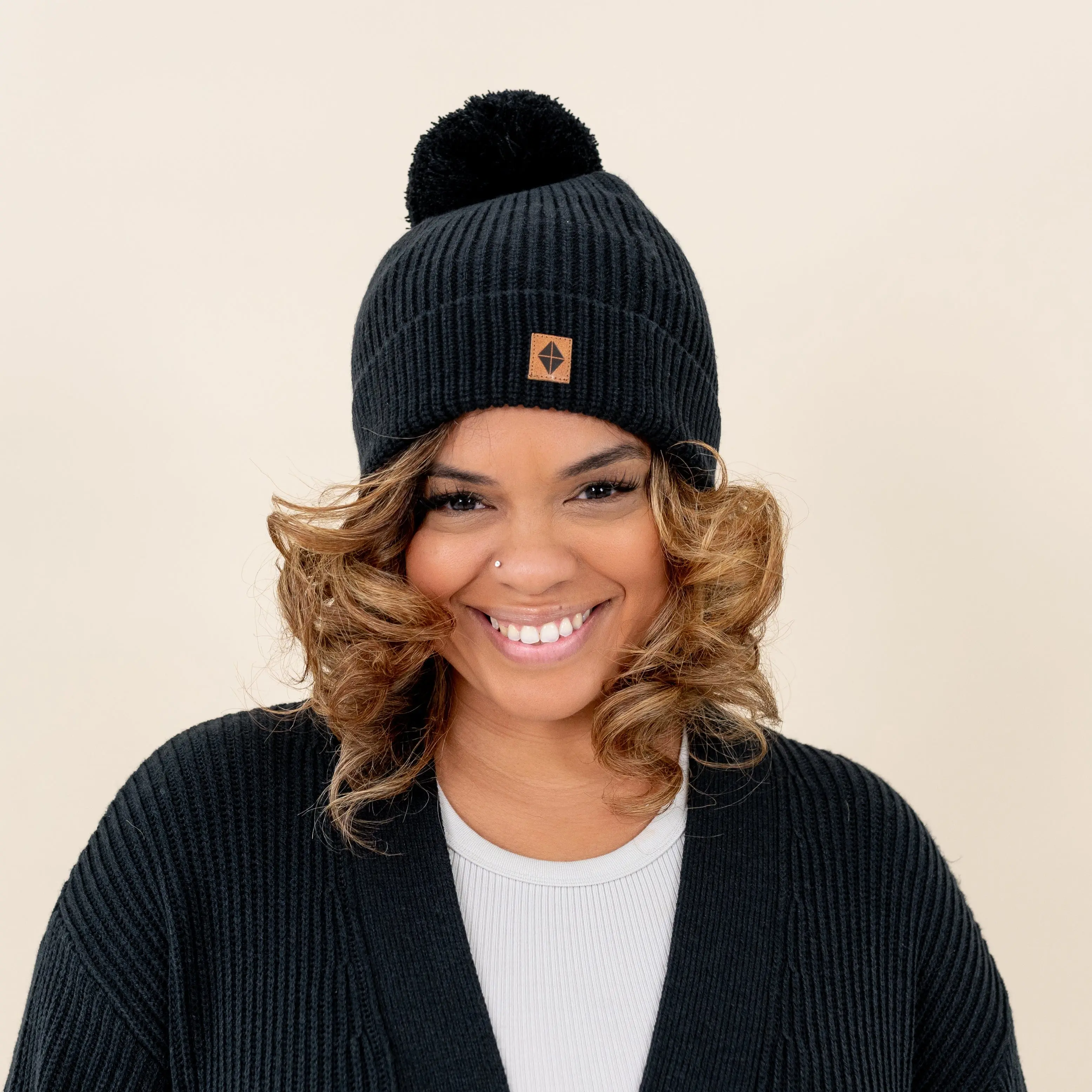 Chunky Knit Pom Beanie for Adults in Midnight - Slouchy Fit with Chic Leather Logo Tag, Soft Acrylic and Bamboo Viscose Blend, Kyte Baby, 30% Viscose Made From Bamboo, Dark Knit Hats
