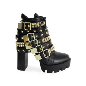 Black platform boots with gold studs, and ornaments