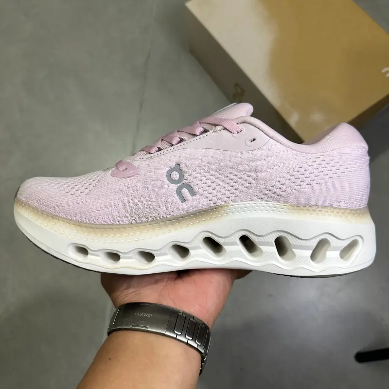 Pink white two-tone hollow cushioned low-top running trainers featuring scuff-proof pale rubber outsoles, tear-resistant sweat-wicking stretch knit mesh construction, mesh embedded airflow cutouts, wavy hollow lightweight foam midsole layout