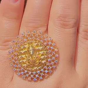 Gold plated lord ganesh adjustable finger ring with white stones on it