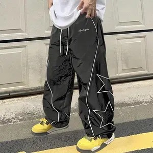 Men’s retro star graphic baggy track pants, soft lightweight material, elastic drawstring waist, great for streetwear, skate culture, casual everyday wear, and hip hop outfits