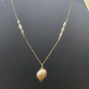 Cowrie Shell Pendant with Gold and Shell Accents Necklace featuring Elegant Bead Chain Design