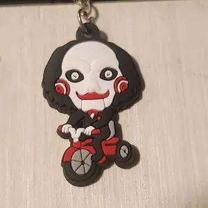 Saw Movie Keychain - Red Tricycle Design with Character Face, Ideal for Fans and Collectors