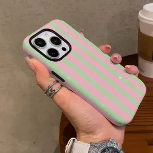 This pink and green striped color-blocked phone case is compatible with iPhone 17, 16, 15, 14, 13, 12, and 11. The 2-in-1 design makes it an ideal upgrade for your phone accessories. Features a vibrant striped pattern.