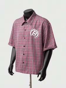 Men’s pink plaid short-sleeve shirt, white "R" logo print with star details, chain decor on collar, camp collar, button closure, rolled-up sleeves, oversized fit, streetwear style, edgy aesthetic, casual daily wear