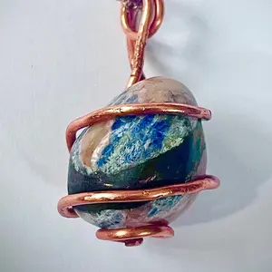 Sodalite Crystal Pendant wrapped in pure copper wire, on a rose plated copper necklace.