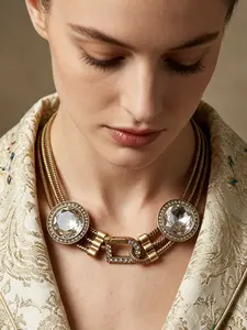 A retro yet elegant distressed gold snake bone necklace adorned with diamonds, featuring dual centerpiece stones and a D-shaped diamond clasp, suitable for various occasions such as evening parties, vintage outfits, and light business wear.
