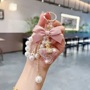 Creative Water Bottle Keychain Fashion Bow Perfume Bottle Bag Charm Elegant Pearl Chain Car Key Ring Gift Accessory