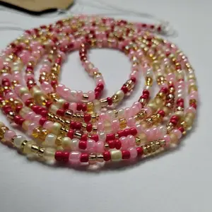 Waistbeads - Strawberry Shortcake is filled with Reds, Pinks, Cream and Gold. 60 inches that’s fits up to a 4Xl and 70 inches that’s fits 5Xl