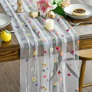 Floral embroidered daisy table runner, perfect for seasonal decor. Comes with a tulle tablecloth, making it ideal for home decor at holidays, in kitchen-dining areas, at parties, for bridal showers, weddings, craft projects, and more.