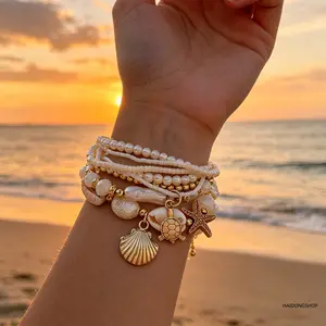 Women’s stackable bracelet set—handmade boho coastal shell and starfish wrist jewelry with faux pearls; an exquisite, trendy layered beach accessory that’s versatile for summer beach vacations, pool parties, and everyday casual outfits.