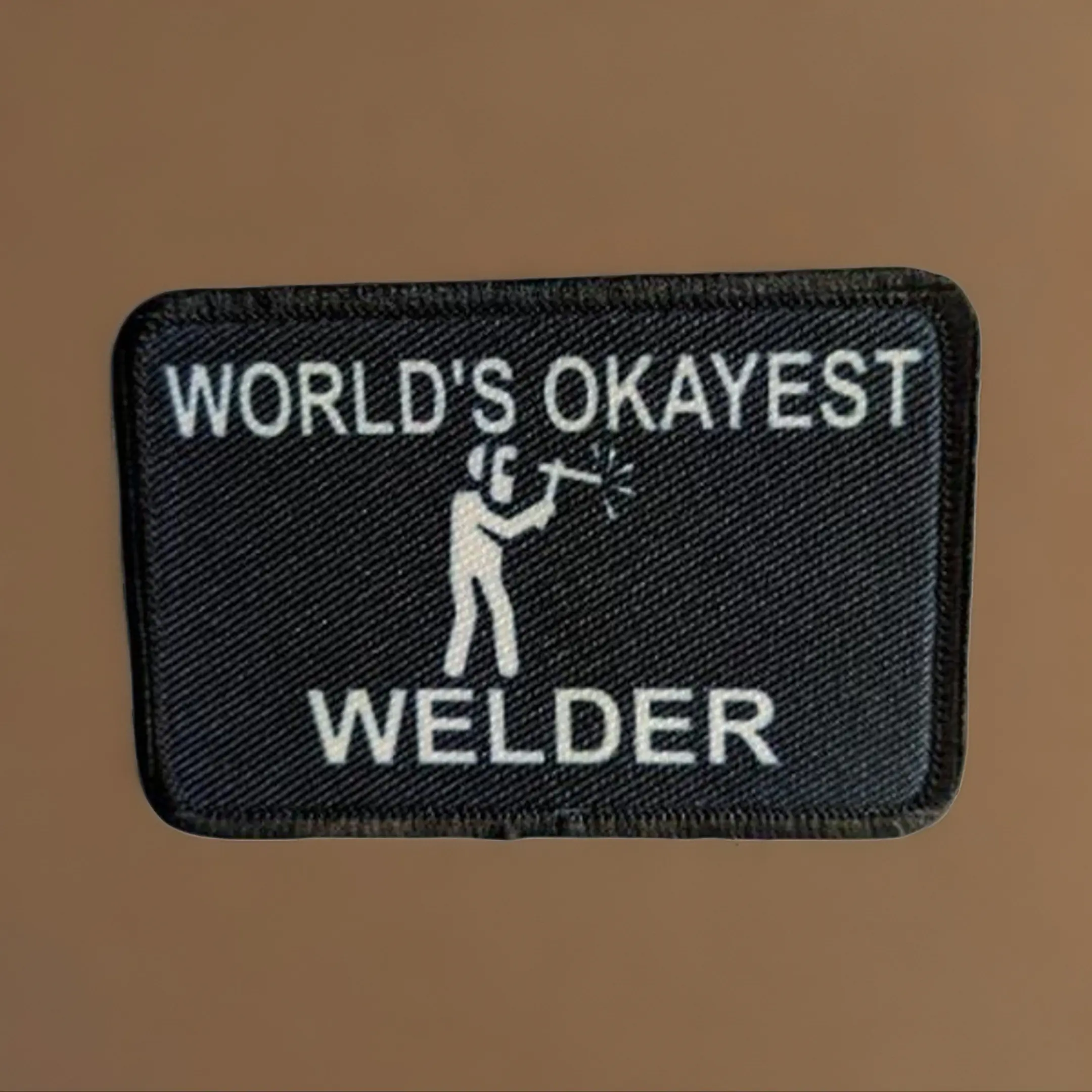 World's okayest Welder blue collar welding 2"x3" morale patch with hook and loop backing