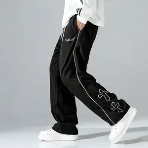 Men’s wide-leg pants with a cross print, drawstring elastic waistband, made from polyester fabric—comfortable and breathable, loose with a drapey feel that resists wrinkles. Suitable for street style, everyday casual wear, and outdoor outfits.